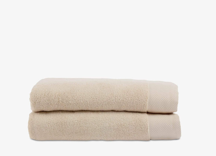 Set of bone coloured stacked cotton envello Bath Towels