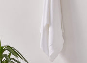 White envello Bath Towel hanging on hook