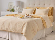 envello Crisp Chambray yellow sheet set on bed with breakfast tray