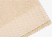Detailed view of envello bone coloured cotton Washcloths